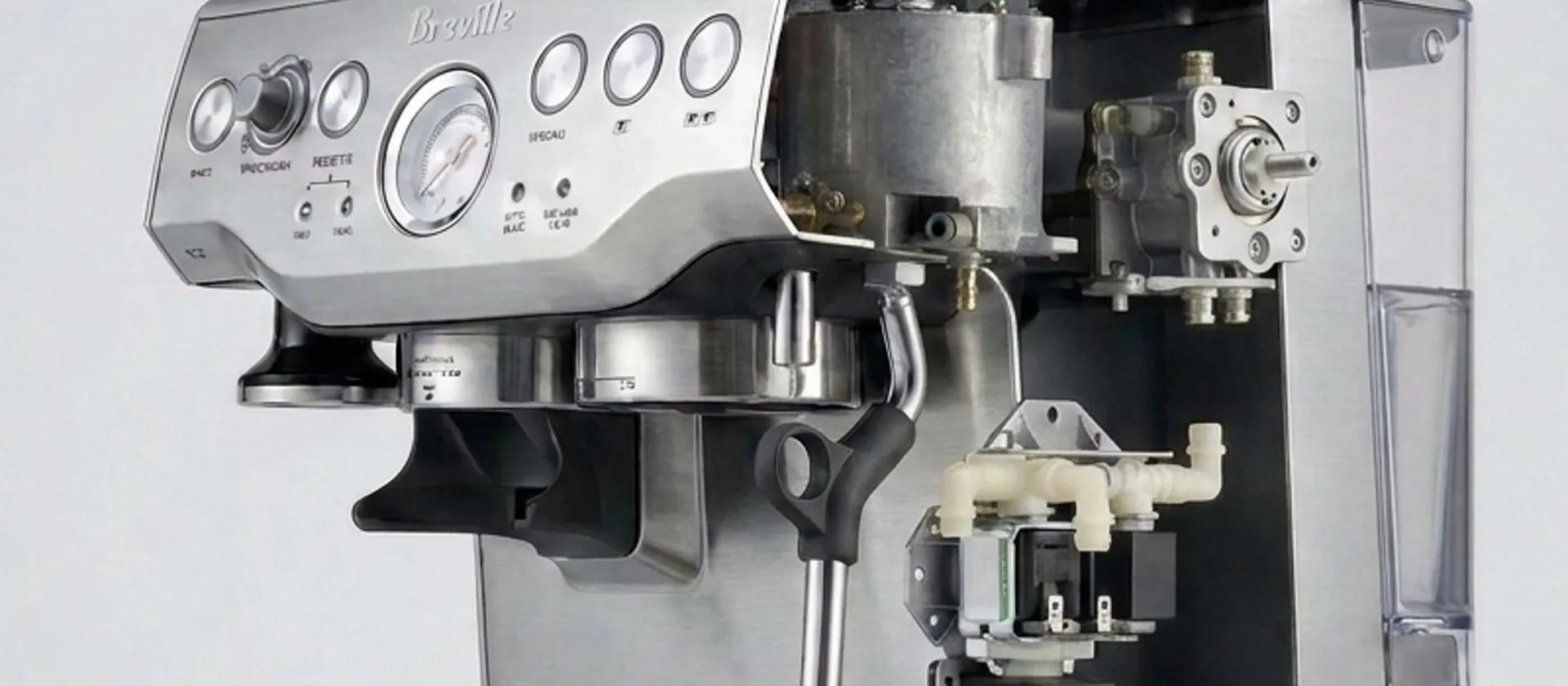 Breville Barista Express with the right side of the casing cut away, showing the thermocoil, the solenoid block, the pump and the flow meter in place